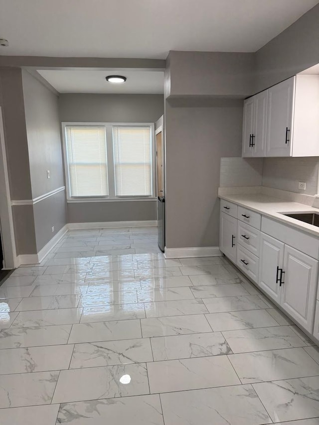 kitchen with white cabinetry and sink