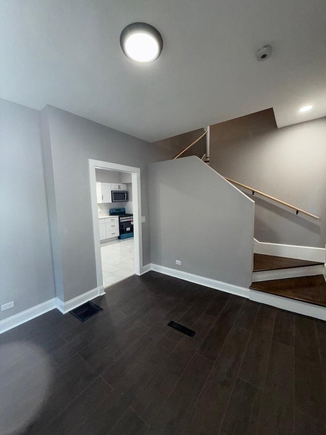 unfurnished living room featuring dark hardwood / wood-style flooring