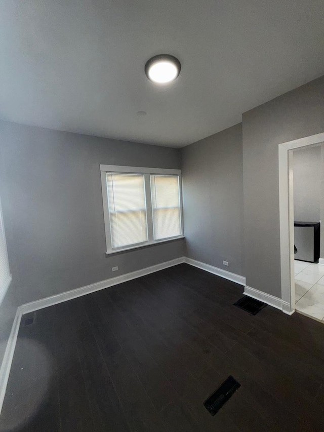 spare room with hardwood / wood-style flooring