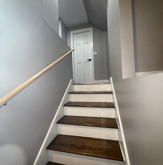 stairway with vaulted ceiling