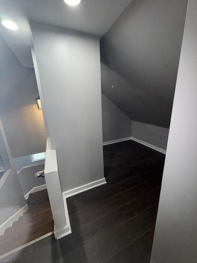 bonus room featuring dark hardwood / wood-style floors and vaulted ceiling