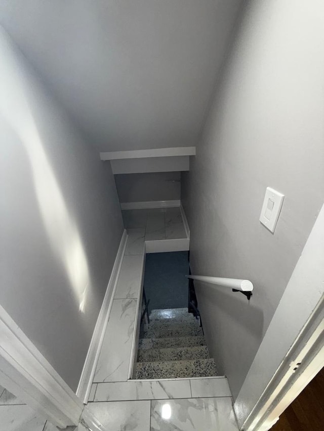 staircase featuring lofted ceiling