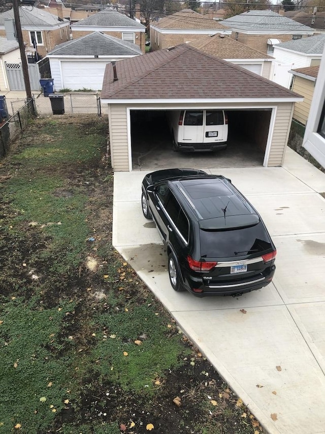 view of vehicle parking featuring a garage