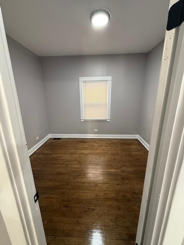 empty room with dark wood-type flooring