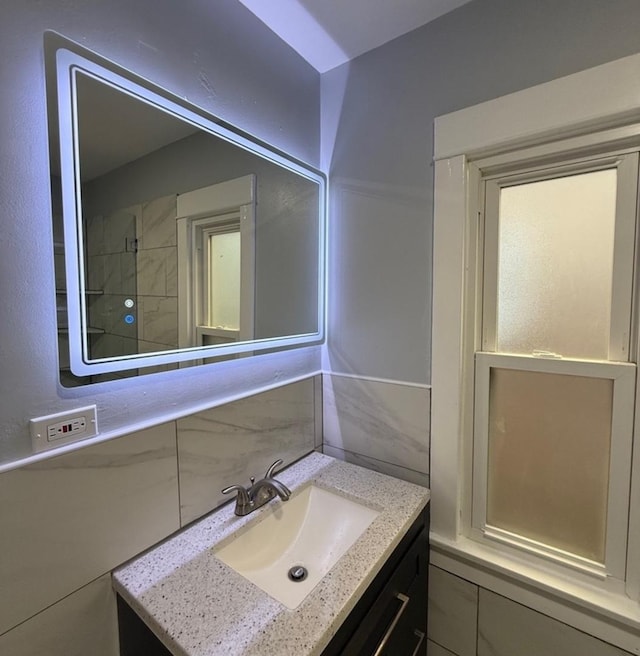 bathroom with vanity and tasteful backsplash