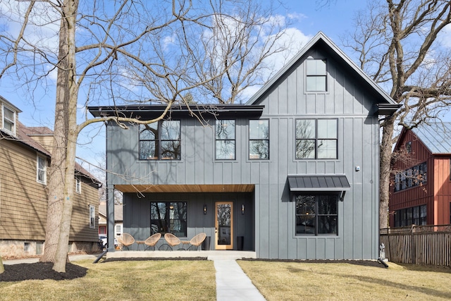 modern farmhouse style home featuring a front yard