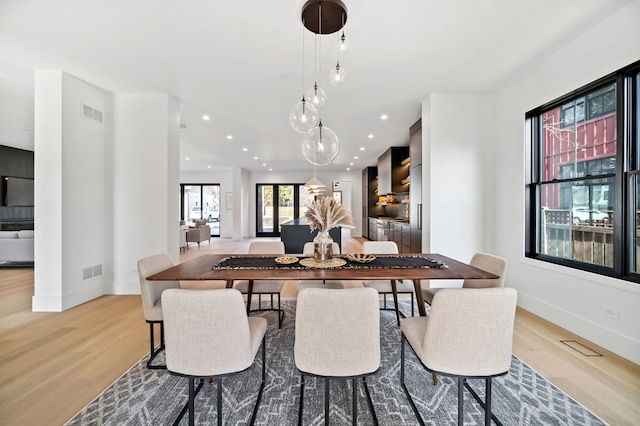 dining space with light hardwood / wood-style floors