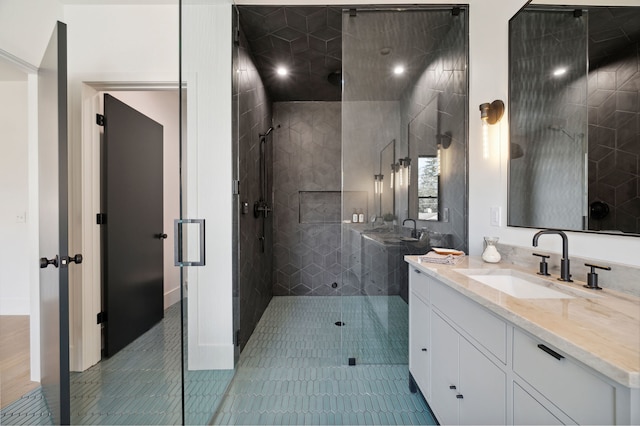 bathroom featuring vanity, tile patterned floors, and a shower with door