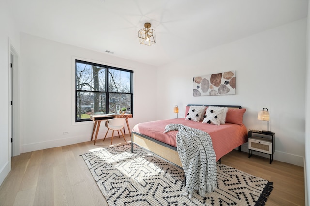 bedroom with wood-type flooring