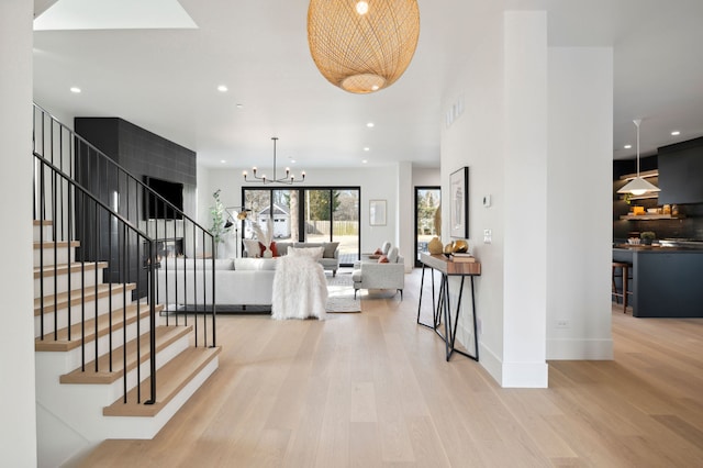 interior space with light wood-type flooring and a chandelier