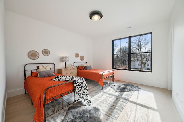 bedroom with wood-type flooring