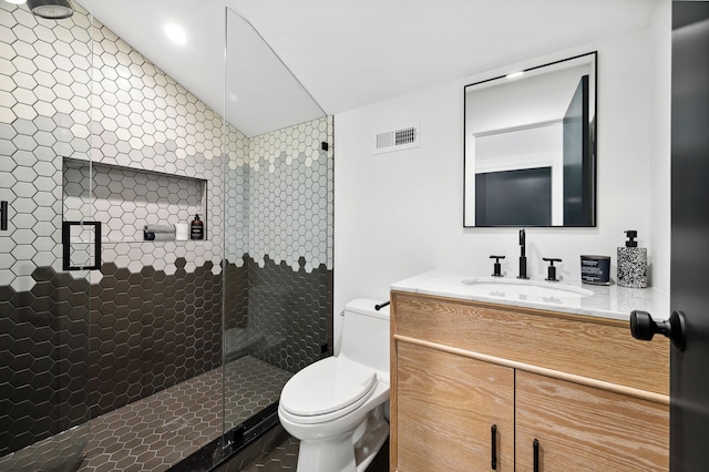 bathroom with vanity, lofted ceiling, toilet, and an enclosed shower