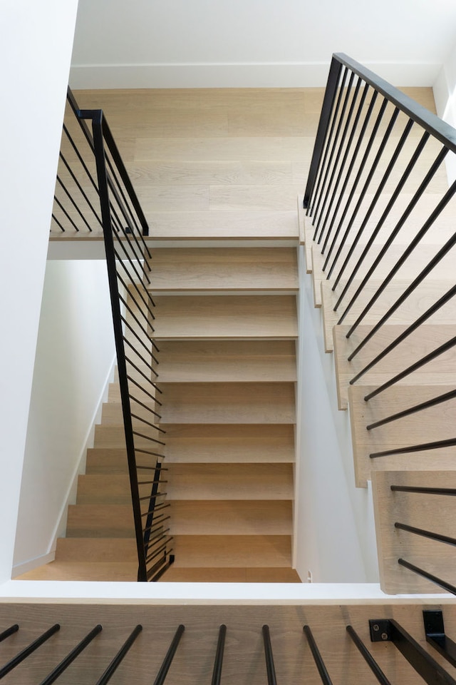 stairs with hardwood / wood-style floors