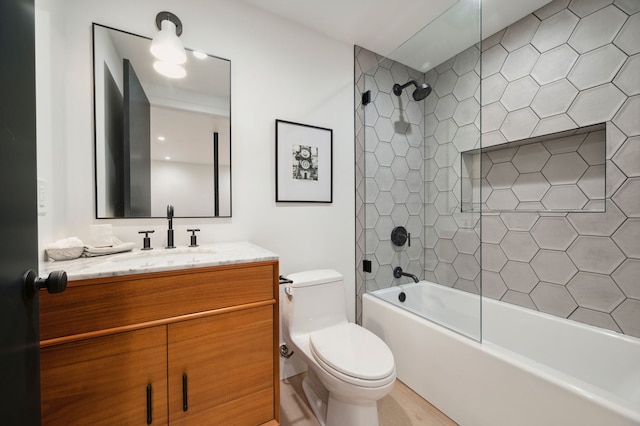 full bathroom featuring vanity, toilet, and tiled shower / bath