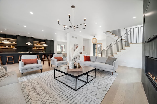 living room featuring light hardwood / wood-style floors and sink