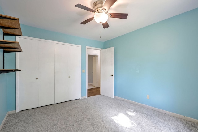 unfurnished bedroom with a closet, ceiling fan, and light colored carpet