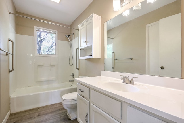 full bathroom featuring vanity, bathtub / shower combination, hardwood / wood-style floors, and toilet