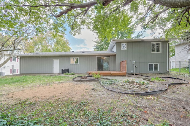 back of house with a wooden deck, a patio, and cooling unit