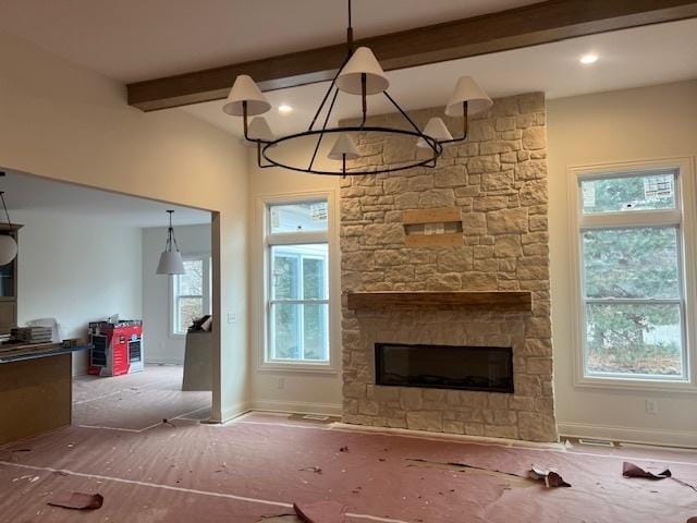 unfurnished living room with a fireplace and beam ceiling