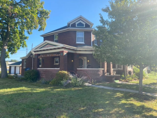 view of front of house featuring brick siding, a porch, and a front lawn