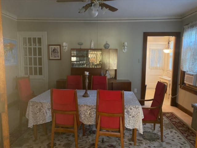 dining room with ceiling fan, cooling unit, and crown molding