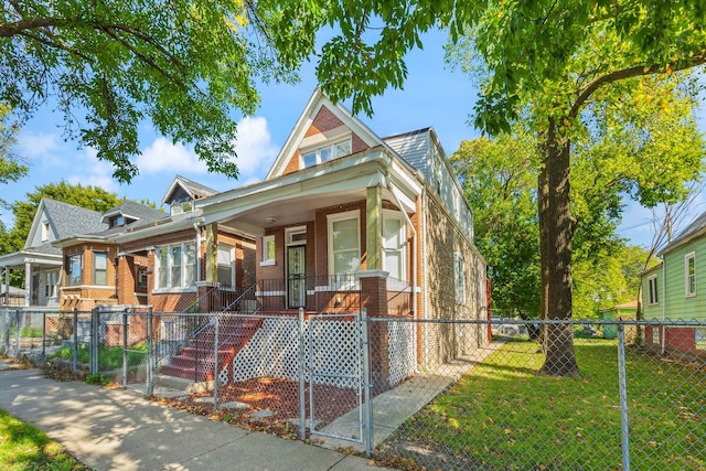 view of front facade featuring a front yard and covered porch