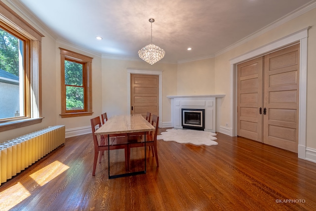 dining room featuring crown molding, dark hardwood / wood-style flooring, radiator heating unit, and a notable chandelier