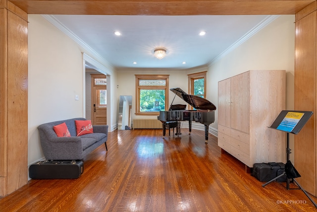 living area with radiator heating unit, ornamental molding, and dark wood-type flooring