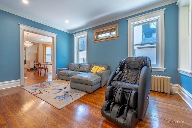 living room featuring ornamental molding, radiator, and wood-type flooring