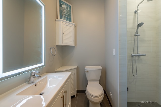 bathroom featuring tile patterned flooring, walk in shower, vanity, and toilet