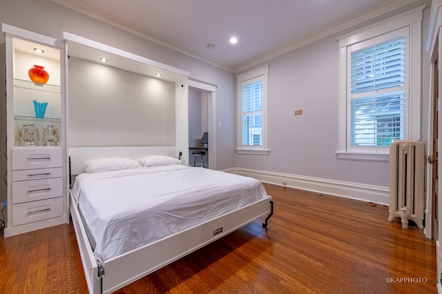 bedroom featuring crown molding, radiator, and dark wood-type flooring