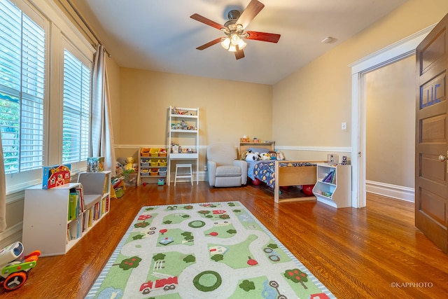 bedroom with ceiling fan and dark hardwood / wood-style flooring