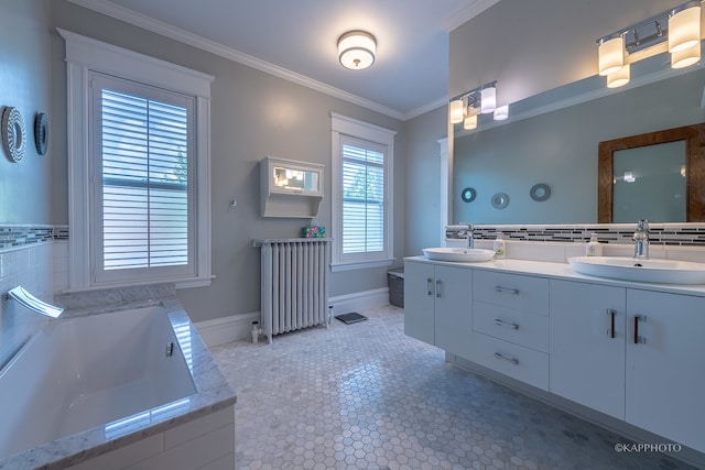 bathroom with vanity, radiator, tiled bath, and crown molding