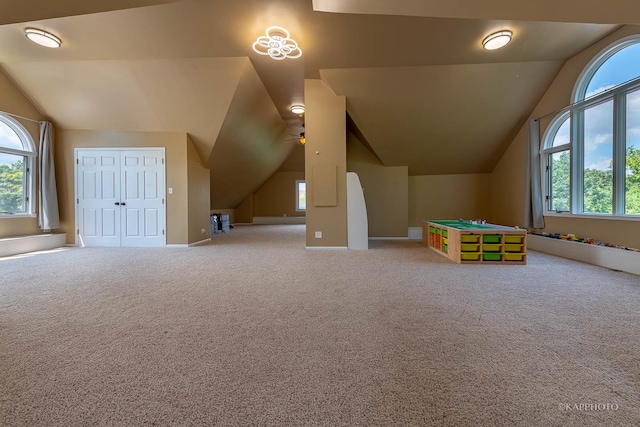 rec room with carpet, a wealth of natural light, lofted ceiling, and ceiling fan