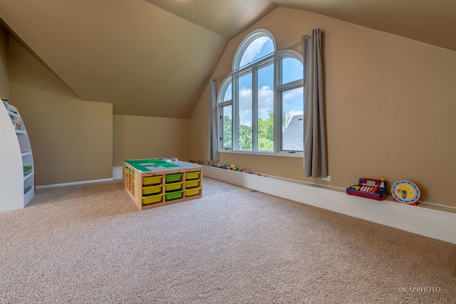 rec room featuring carpet flooring, vaulted ceiling, and a healthy amount of sunlight