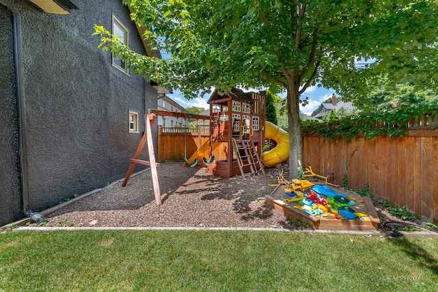 view of playground with a lawn