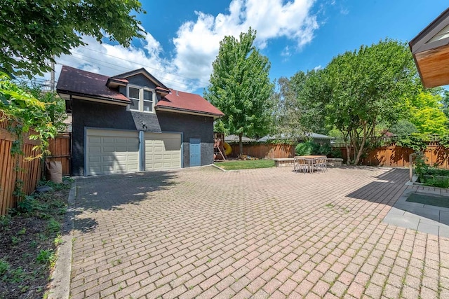 exterior space with a patio and a garage