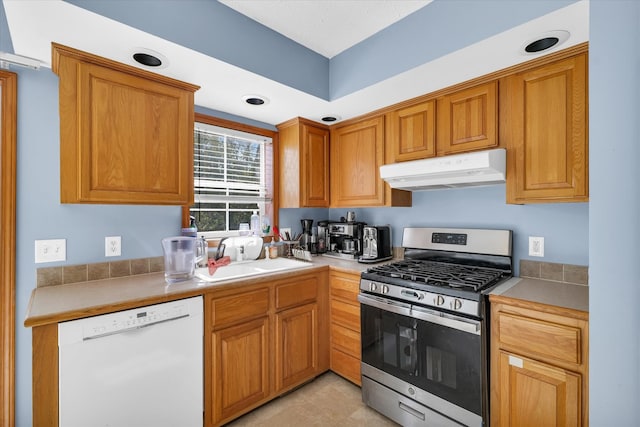 kitchen featuring sink, white dishwasher, and stainless steel gas range