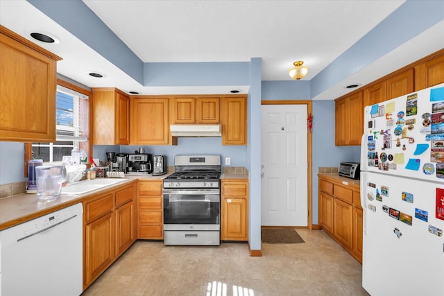 kitchen featuring white appliances and sink