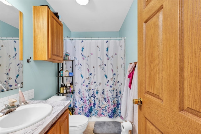 bathroom featuring vanity, a shower with curtain, and toilet