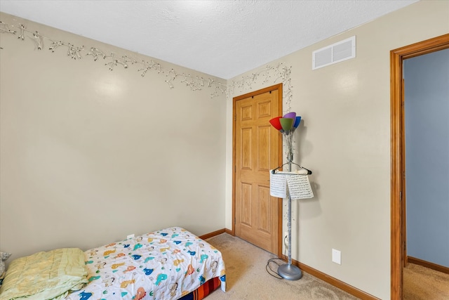 carpeted bedroom with a textured ceiling