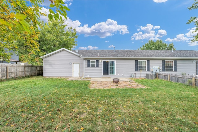 rear view of property featuring a patio, cooling unit, and a lawn