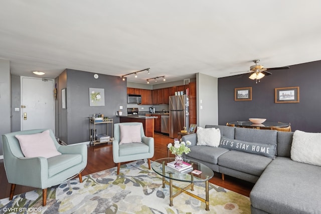 living room featuring ceiling fan and hardwood / wood-style flooring