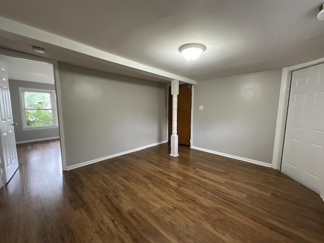 basement with dark hardwood / wood-style floors