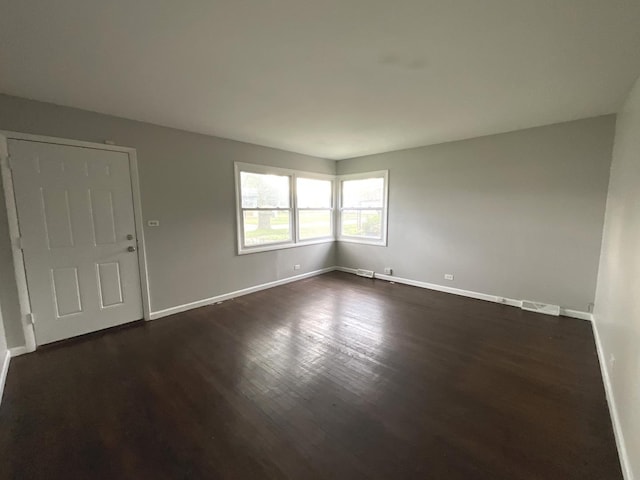 spare room with dark hardwood / wood-style floors