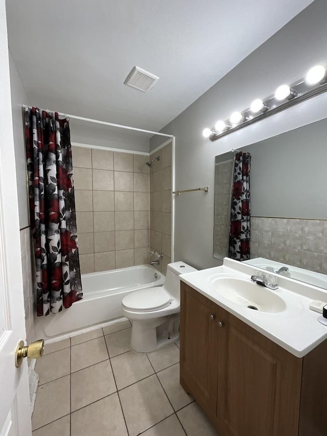 full bathroom featuring toilet, shower / bath combo with shower curtain, vanity, and tile patterned flooring