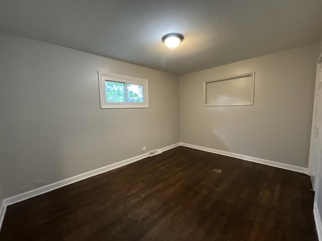 empty room featuring dark hardwood / wood-style flooring