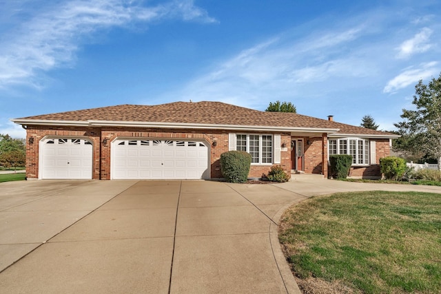 ranch-style house featuring a front yard and a garage