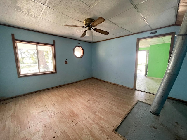 spare room featuring light hardwood / wood-style floors, a paneled ceiling, and ceiling fan