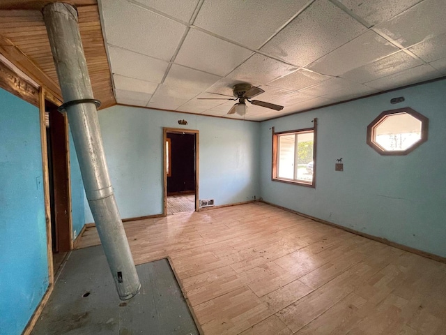 interior space with a paneled ceiling, light wood-type flooring, and ceiling fan